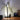 Bananen tafellamp wit zwart modern design naast slimme speaker op houten tafel.