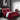 Rood gestreept dekbedovertrek op bed in moderne slaapkamer met grijze muren en raam.