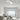 Witte Chio wandlamp in moderne woonkamer, plafondmontage, minimalistisch design.