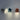 Drie moderne wandlampen in grijs, blauw en bruin, minimalistisch design, LED-verlichting.