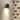 Bruine wandlamp op patroonbehang met egels en driehoeken, sfeerverlichting, modern interieur.