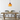 Houten eettafel met zwarte stoelen en oranje hanglamp in moderne eetkamer.