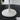 Witte Fontana tafellamp op zwarte tafel, modern design, minimalistisch interieuraccessoire.