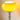 Gele glazen tafellamp met chromen voet, moderne verlichting, interieurdecoratie.