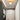 Gouden plafondlamp met bolvormige lamp in moderne hal, minimalistisch interieurontwerp.