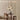 Drie hanglampen boven houten eettafel, moderne inrichting, minimalistisch design, beige tinten.