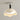 Moderne beige plafondlamp, golvende kap, zwart-witte details, eigentijds interieurontwerp.