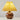 Gele tafellamp met houten bolvormige voet en geplooide kap, moderne verlichting, interieurdecoratie.