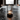 Moderne glazen tafellamp met metalen frame, sfeerverlichting, minimalistisch design, zwart.