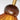 Houten plafondlamp met amberkleurige glazen kap, moderne verlichting, goudkleurige details.