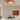 Terracotta plafondlamp in moderne woonkamer, minimalistisch interieur, beige en bruine tinten.