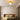 Gouden plafondlamp in moderne slaapkamer, strakke inrichting, sfeerverlichting, designlamp.