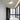 Moderne witte plafondlamp met houten detail in minimalistische badkamer.