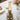 Vintage tafellamp met glazen kap, LED-verlichting, beige basis, naast bloemen en servies.