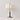 Witte stoffen tafellamp met bloemenpatroon, moderne metalen voet, elegante woondecoratie.