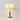 Witte stoffen tafellamp met houten voet en messing details, elegante verlichting voor interieur.