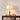 Orchidee stoffen tafellamp, beige kap, messing voet, decoratieve kast, sfeerverlichting.
