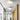 Moderne witte plafondlamp met houten details in minimalistisch interieur.