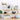 Wandplank met decoratieve items: klok, fotolijst, planten, camera, boeken, mok, houten planken.