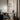 Moderne glazen hanglamp boven bureau, zwart frame, minimalistisch design, interieurverlichting.