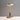 Gouden tafellamp met glazen kap, modern design, houten accent, sfeerverlichting.