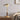 Gouden tafellamp met glazen kap op houten tafel, modern design, sfeerverlichting woonkamer.