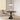 Ronde zwarte eettafel met moderne stoel en hanglamp in minimalistisch interieur.
