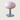 Roze glazen tafellamp met chromen voet, modern design, sfeerverlichting, interieurdecoratie.