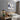 Moderne slaapkamer met houten bed, nachtkastje, wandlampen en paardenkunst aan de muur.