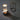 Moderne tafellamp met glazen cilinder en metalen basis, sfeerverlichting, industrieel design.
