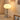 Moderne tafellamp met chromen bolvormige voet en witte glazen kap, sfeerverlichting.