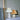 Twee geplooide tafellampen, wit en beige, op tafel met decoratieve elementen.