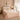Luxe beige beddengoed set op tweepersoonsbed in elegante slaapkamer met decoratieve kussens.