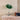 Groene UFO tafellamp met chromen standaard op houten kast, retro design, moderne verlichting.