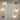 Moderne gouden wandlampen met glazen cilinders, minimalistisch design, sfeerverlichting.