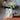 Witte papieren vaas met bloemen op oranje tafel, moderne decoratie, minimalistisch design.