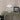 Witte tafellamp op groene kast, modern design, interieurdecoratie, minimalistische stijl.
