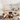 Gezellige woonkamer met witte banken, houten salontafel, hanglamp en decoratieve accessoires.