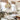 Hanglamp rotan design, moderne woonkamer, witte bank, groene kussens, Scandinavische stijl.