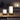 Tafellamp Cleo Lantaarn, zwart metaal, wit glas, moderne buitenverlichting, sfeervol design.