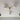 Moderne plafondlamp met drie witte glazen bollen en messing armatuur.