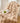 Beige pluche deken op stoel met groene appel en krant, luxe interieurdecoratie.