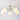 Moderne plafondlamp met vier witte glazen bollen en metalen armatuur, eigentijds design.
