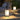 Moderne zwarte lantaarn tafellamp op houten terras, sfeerverlichting buiten.