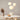 Moderne hanglampen in organische vormen boven eettafel, minimalistisch interieurontwerp.