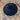 Donkerblauw fluwelen ronde kussen op doorzichtige stoel, decoratief en stijlvol interieuraccessoire.