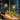 Twee glazen hanglampen boven houten tafel met decoratie, moderne interieurverlichting.