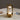 Gouden tafellamp met modern design, LED-verlichting, op marmeren tafel, naast boek en bril.