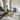 Groene bank en marmeren salontafel in moderne woonkamer met tafellamp en decoratieve kunst.