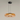 Moderne hanglamp, amberkleurig glas, zwart plafondmontuur, eigentijds interieurontwerp.